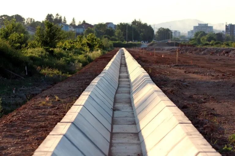 Long,Concrete,Drainage,Channel,Runs,Through,A,Construction,Site,With